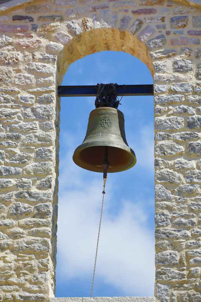 rustic church bell against blue sky